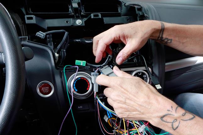 Alex connects the wiring harness plugs